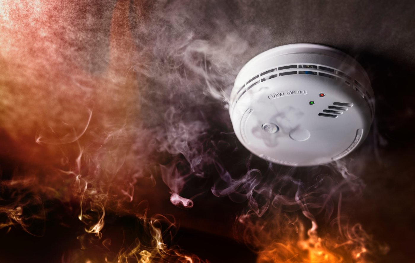 Carbon monoxide and smoke detector on a ceiling detecting smoke