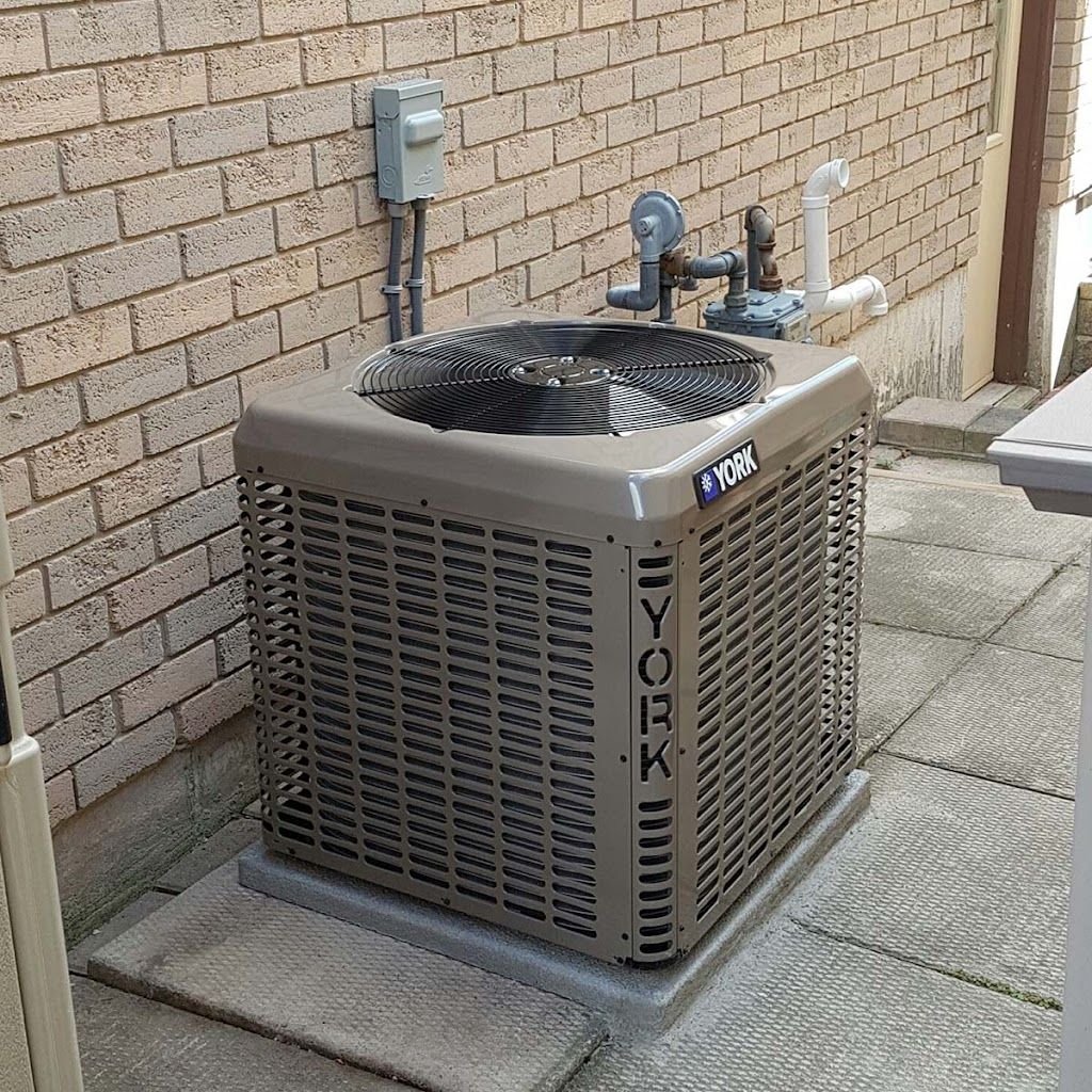 Air conditioner installation next to brick home